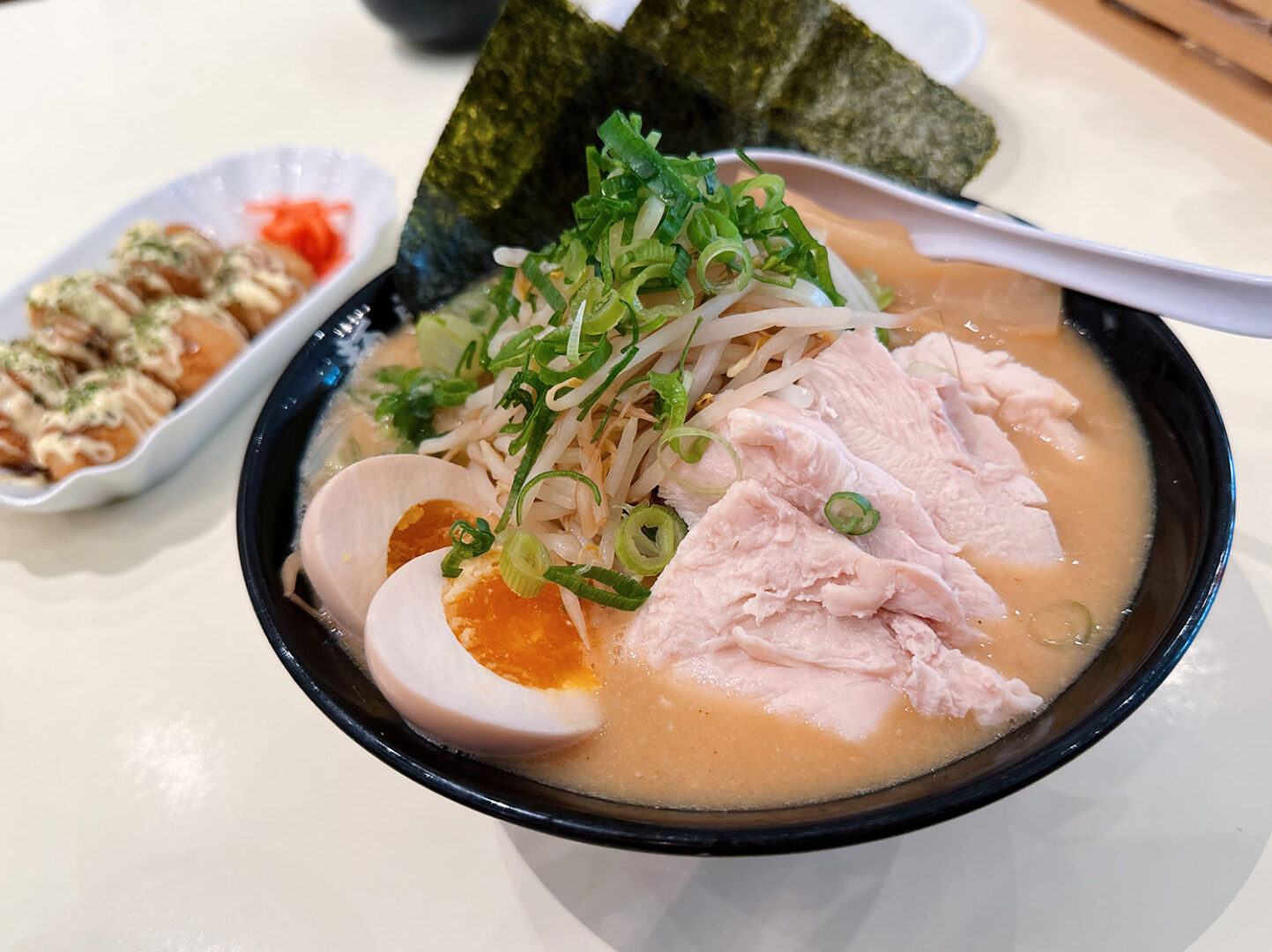 Eine Ramensuppe auf Hühnerbrühenbasis, besonders cremig, mit Ei und Hüherfleisch.