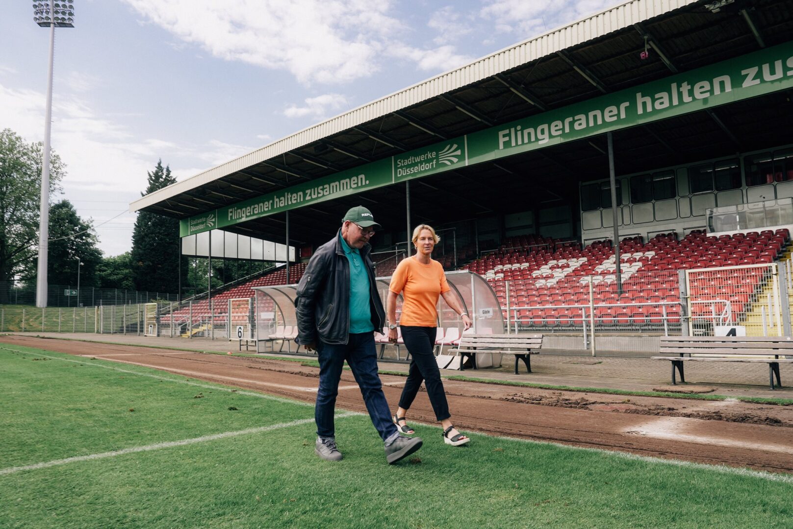 Alle Rhein, der Podcast: Mike Litt und Martina Voss-Tecklenburg gehen über das Spielfeld im Paul-Janes-Stadion