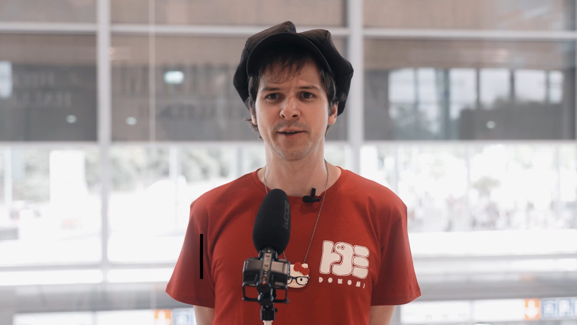 Im Interview: Andreas Degen trägt ein rostrotes T-Shirt  und eine dunkle Ballonmütze.