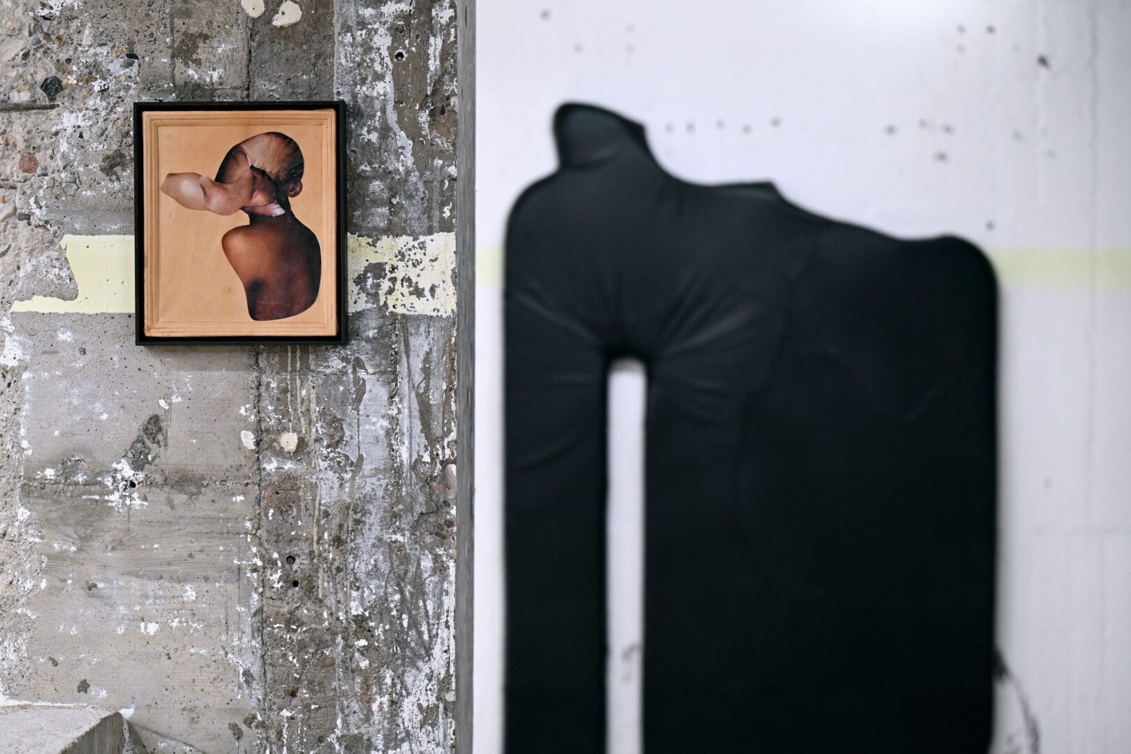 Links ein kleines Bild und im Hintergrund eine tief schwarze Skulptur.